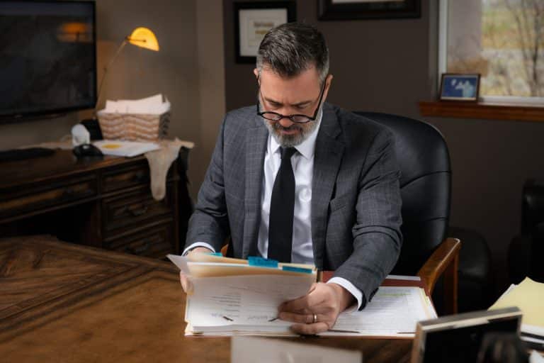 DUI Defense attorney Brian Roach reviewing files at Roach & Bishop Law Offices